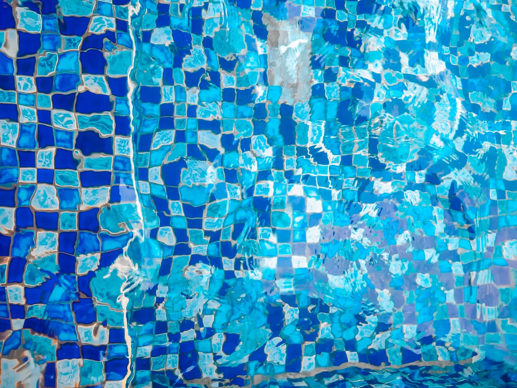 Blue mosaic tile covering the pool floor