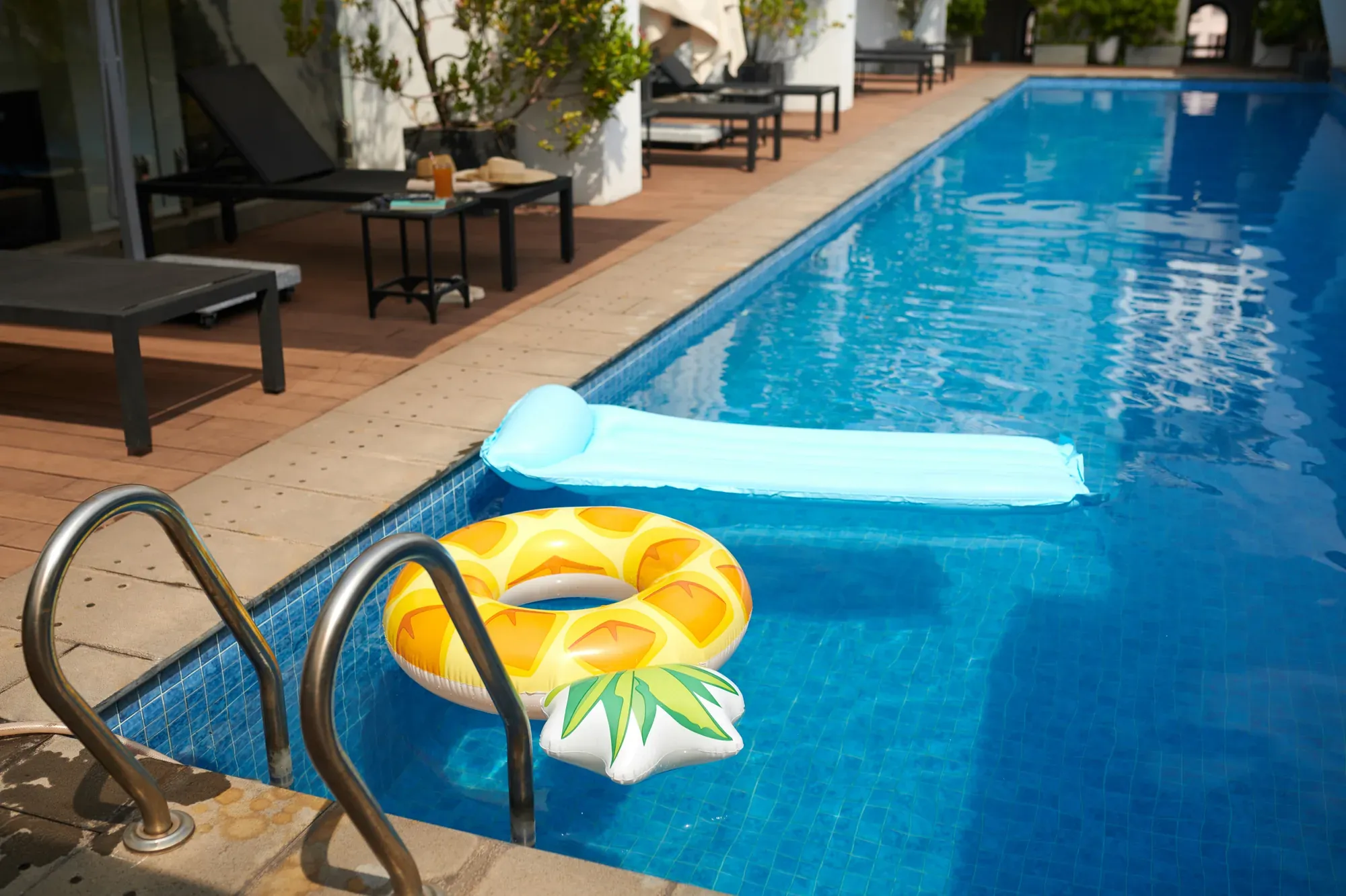 Backyard pool with floats and poolside seating