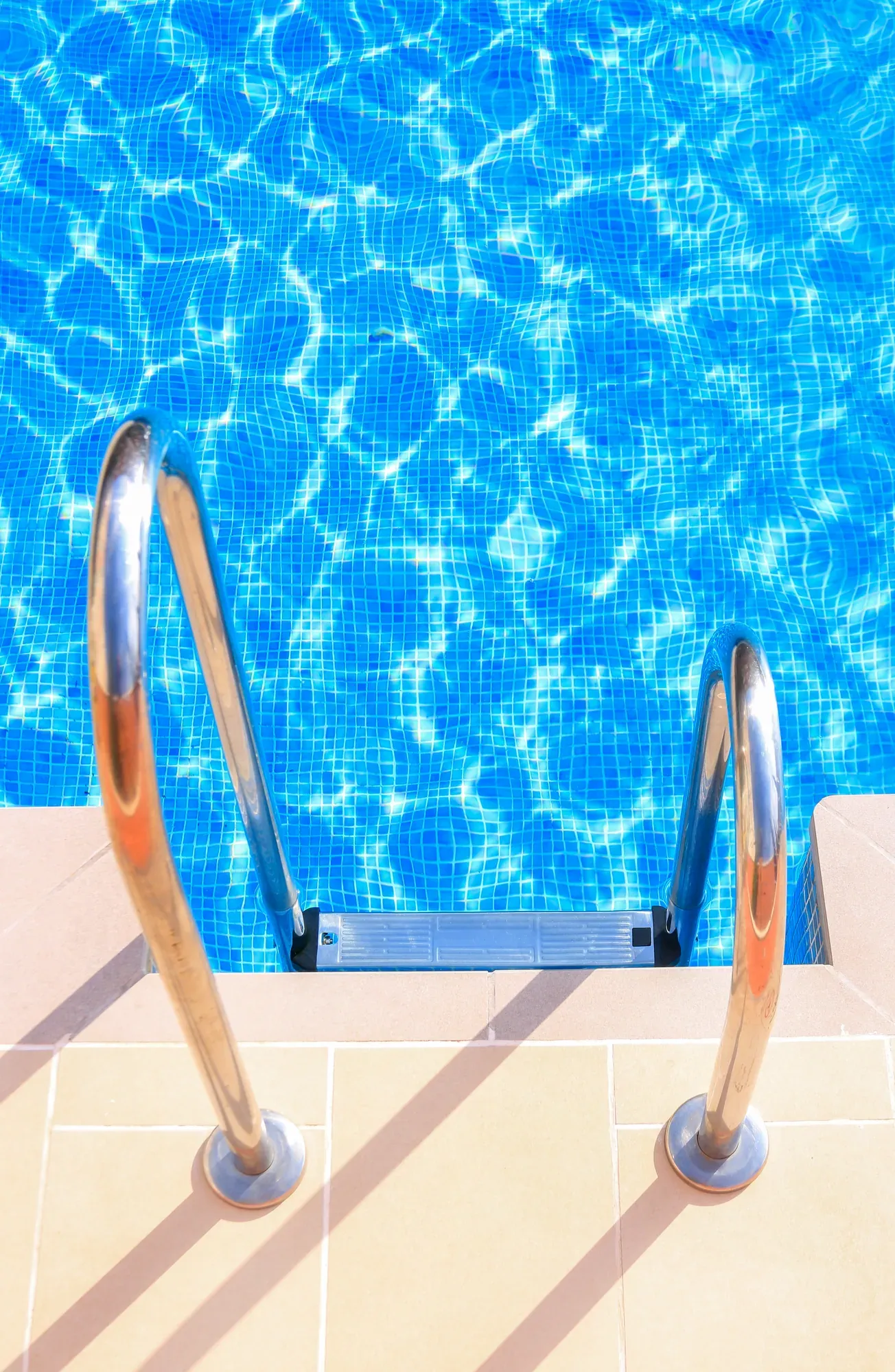 Blue mosaic pool steps seen from above