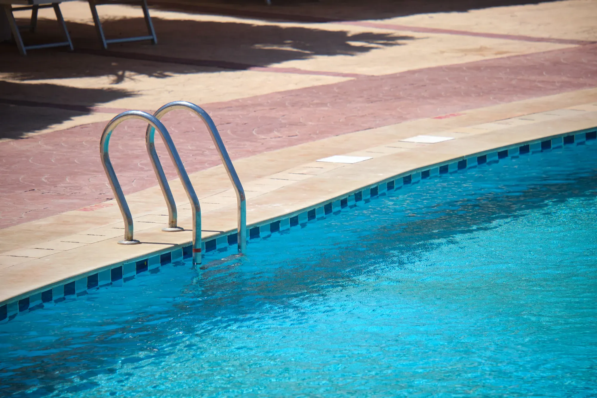 Stainless steel handrails installed at the edge of a pool